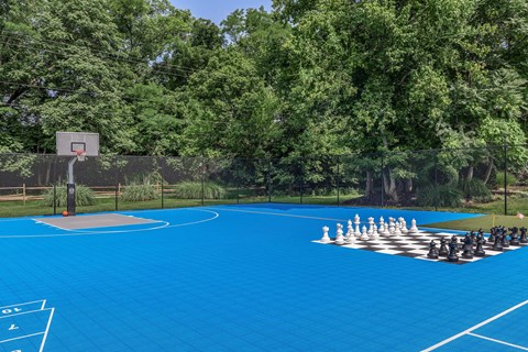 a chess game on a blue basketball court