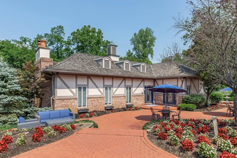 the front of a house with a patio with an umbrella