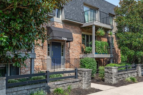 the front of a brick house with a blue door