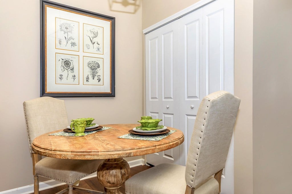 a dining room with a table and chairs