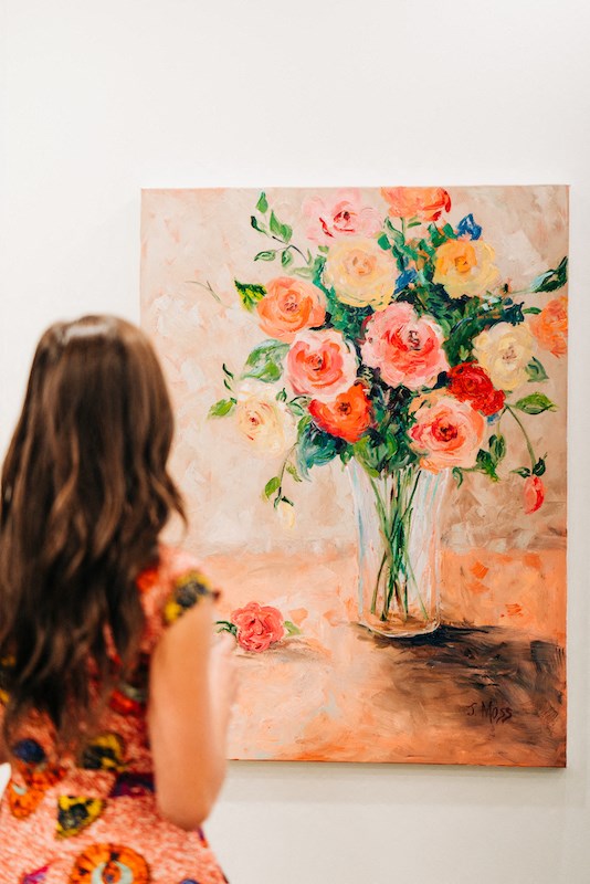 Girl admiring a beautiful rose painting at The Roseberry, Columbia, South Carolina