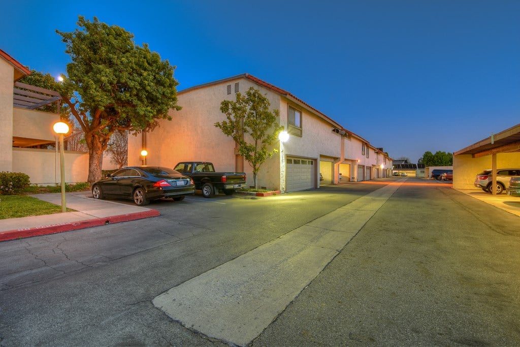 a building with cars parked in front of it at night