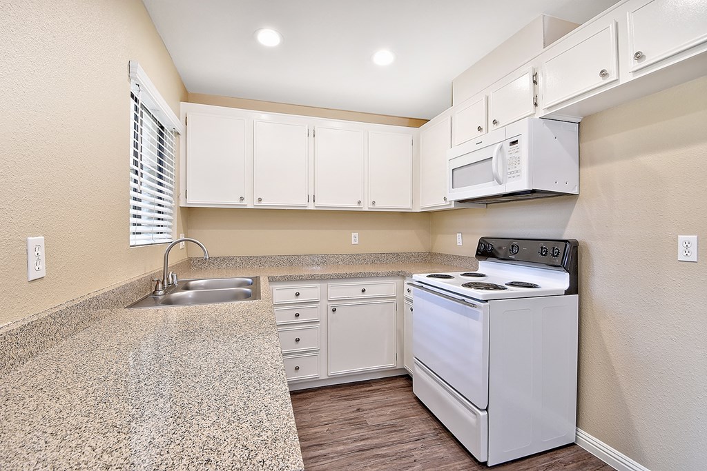 a kitchen with white appliances and white cabinets