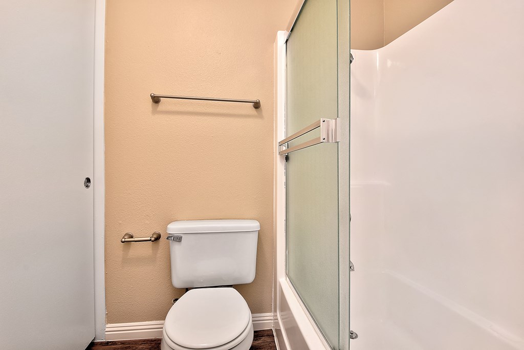 a bathroom with a toilet and a glass shower