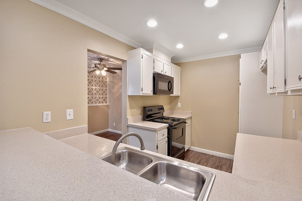 a kitchen with a sink and a stove