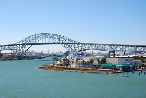 A large bridge spans a body of water with a small island in the middle.