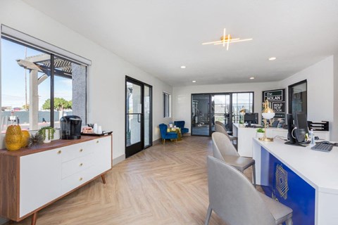 A modern office space with a reception desk and chairs.
