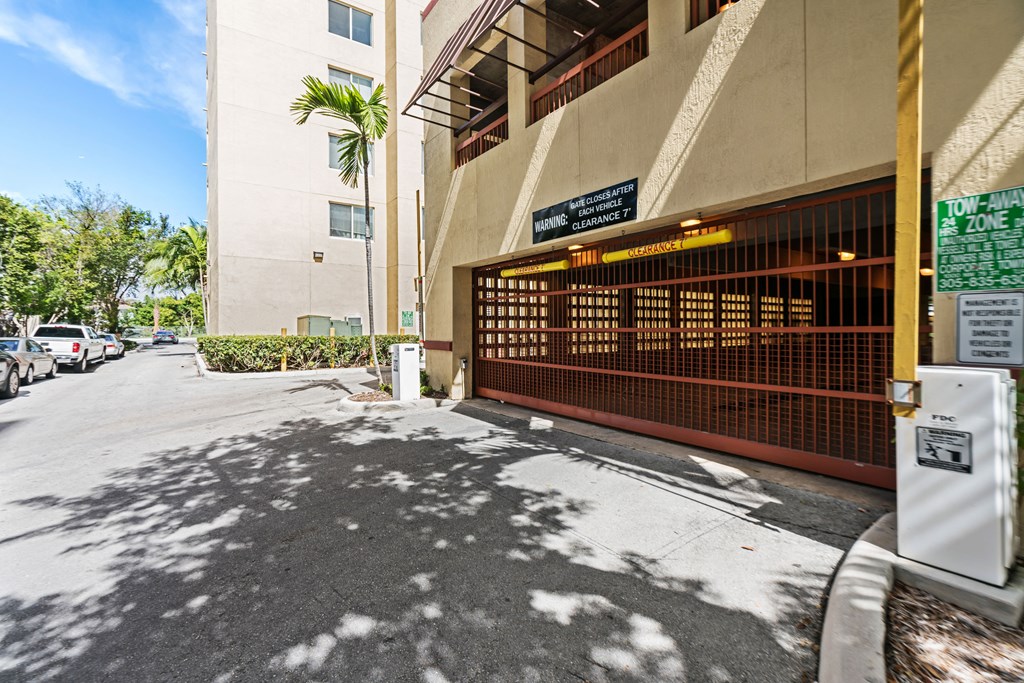 a parking meter in front of a building with a brown gate
