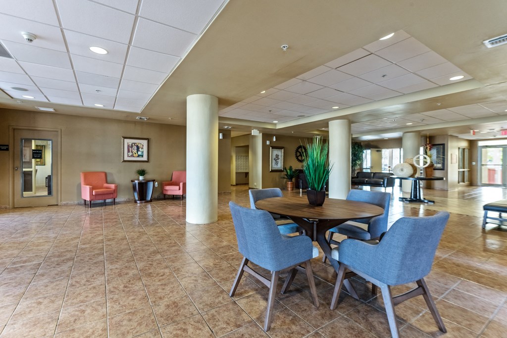 a large lobby with a table and chairs