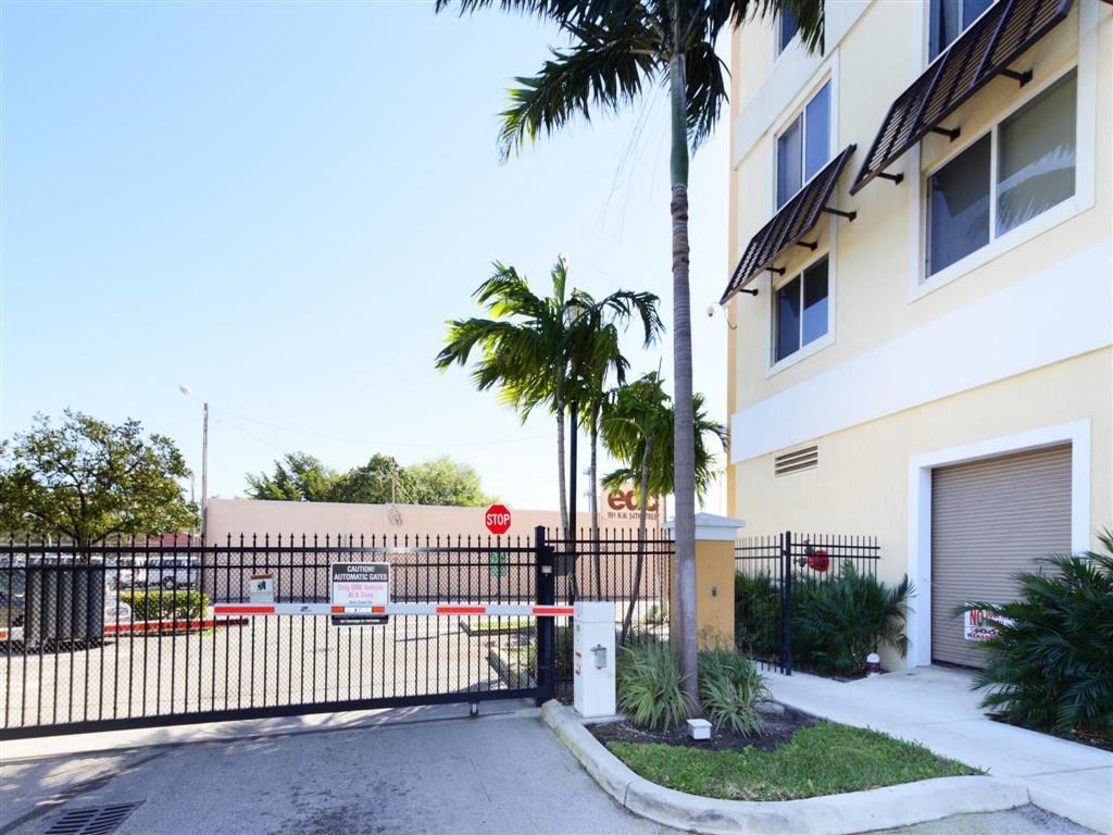 the entrance to a building with a gate and palm trees