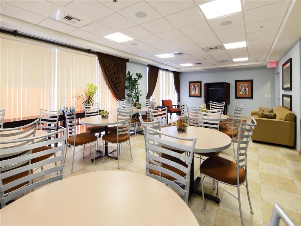a dining room with tables and chairs and a couch