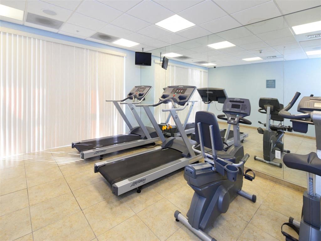 a gym with plenty of machines and weights