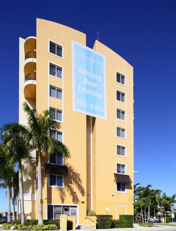a large building with a blue sign in front of it
