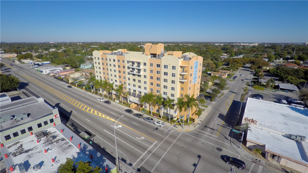 an aerial view of a large building with palm trees