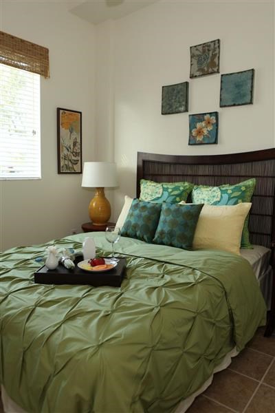 a bedroom with a bed and a tray of food on it