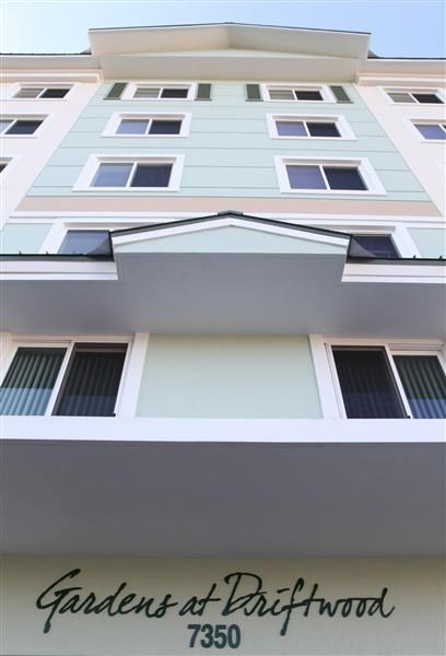 a tall white building with a sign in front of it