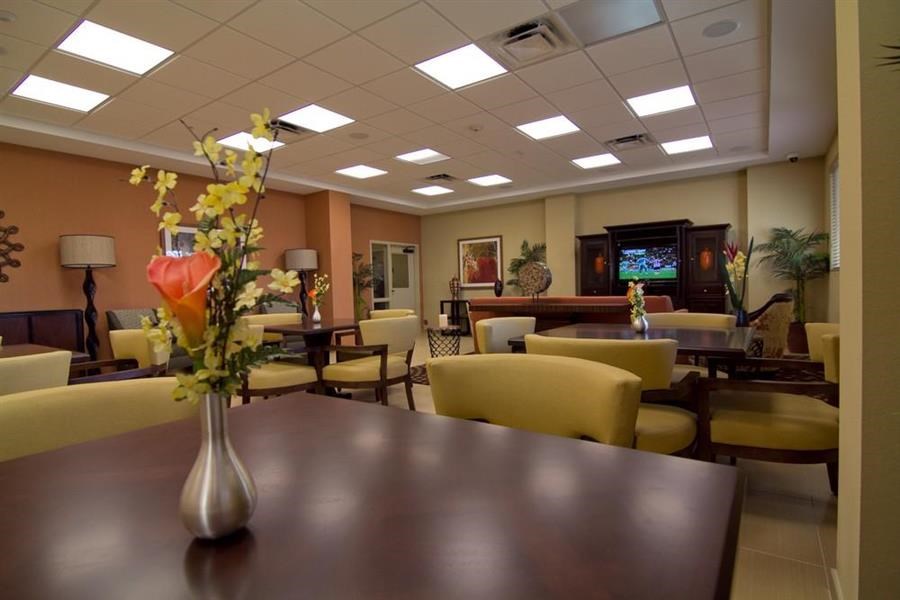 a dining room with a table and a vase with flowers