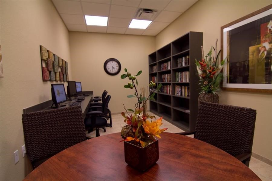 a conference room with a table and a clock on the wall