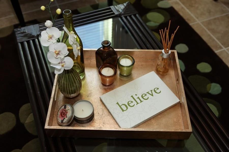 a table with candles and a sign that says believe on it