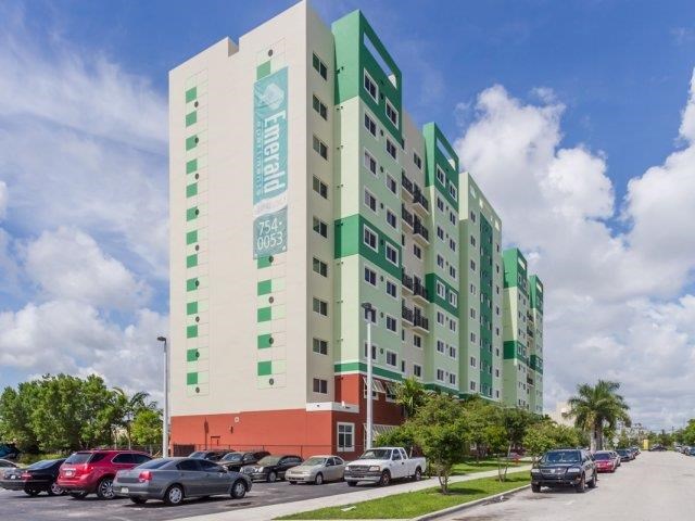 a tall building with cars parked in front of it