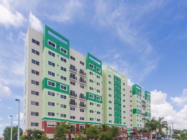 a tall building with many windows and a blue sky