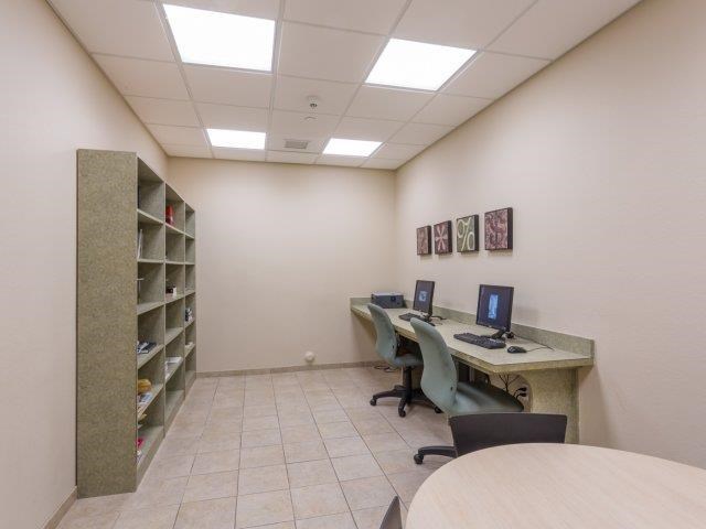 a room with two computers and a table