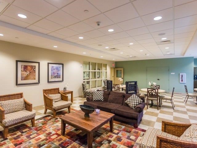 a living room with a couch and chairs and a table