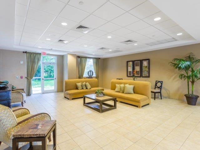 a living room with yellow couches and a table