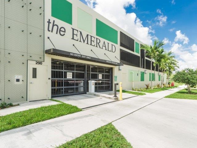 the emerald building has a sidewalk in front of it