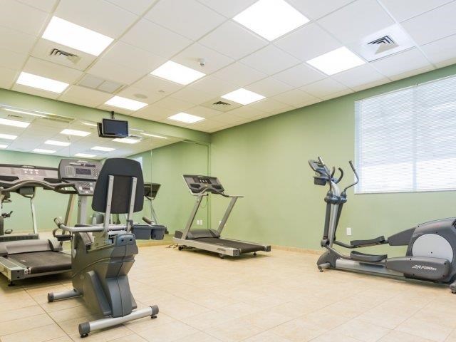 a gym with various exercise equipment in it