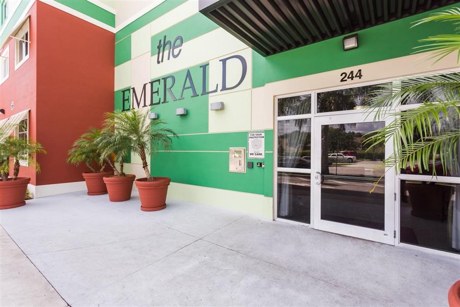 a green and white building with a door