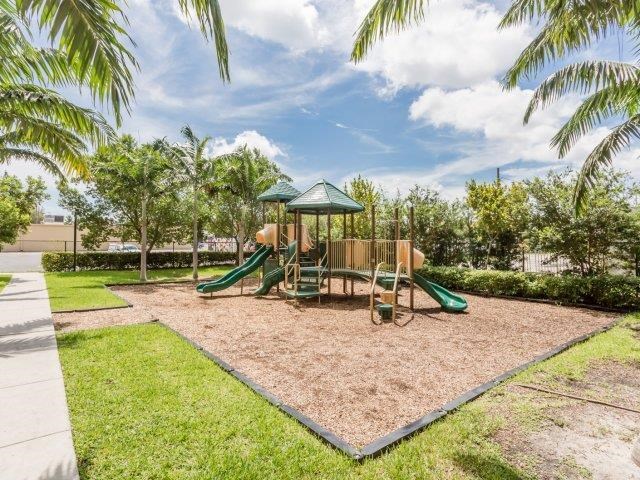 a playground with a swing set in a park