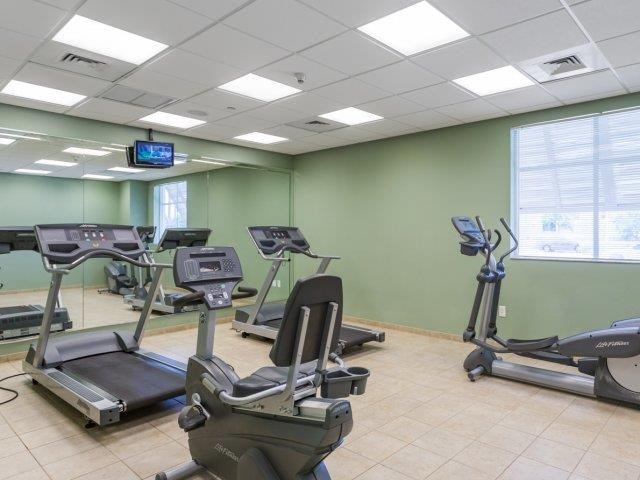 a gym with several pieces of exercise equipment