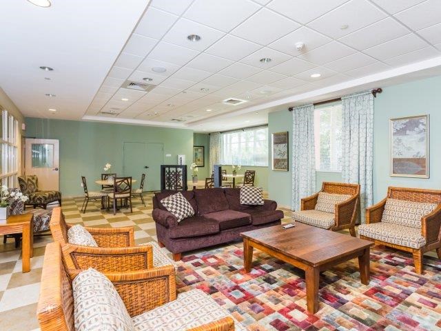 a living room with couches and chairs and a table
