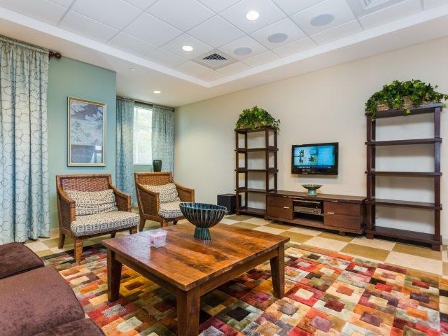 a living room with a table and chairs and a television