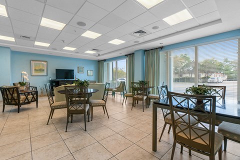 a dining room with tables and chairs and a piano