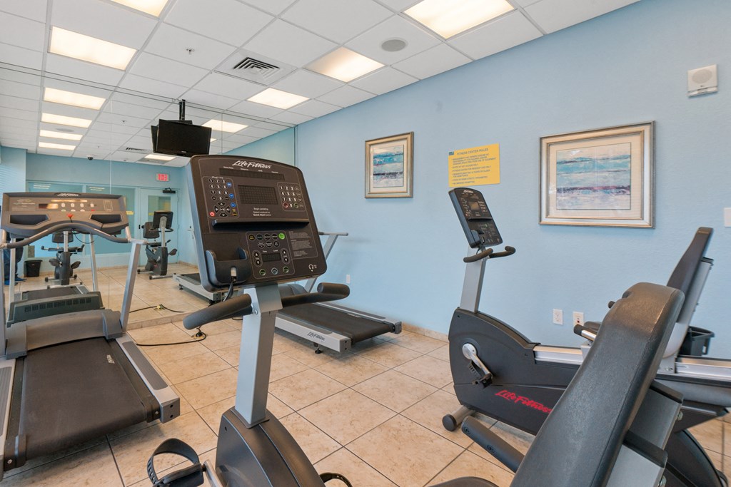 a gym with treadmills and other exercise equipment at our facility