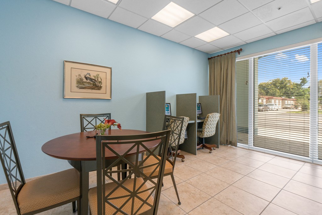 a dining room with a table and chairs and a window