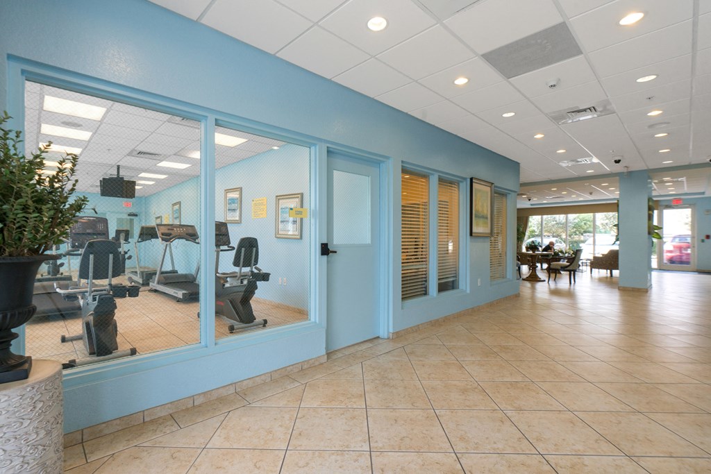 the waiting room of a dental office with blue walls and windows