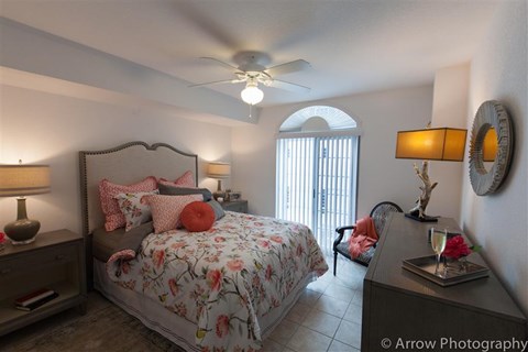 a bedroom with a bed and a ceiling fan