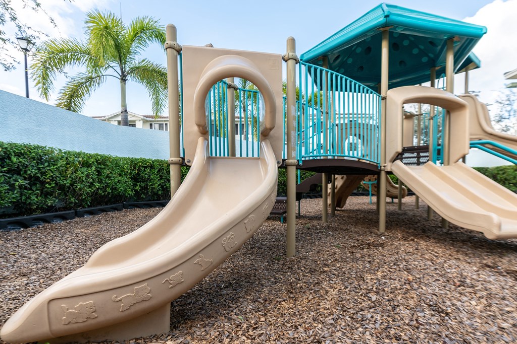 a childrens playground with slides and a playset