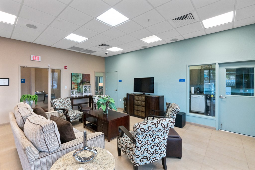 a living room with couches and chairs and a television