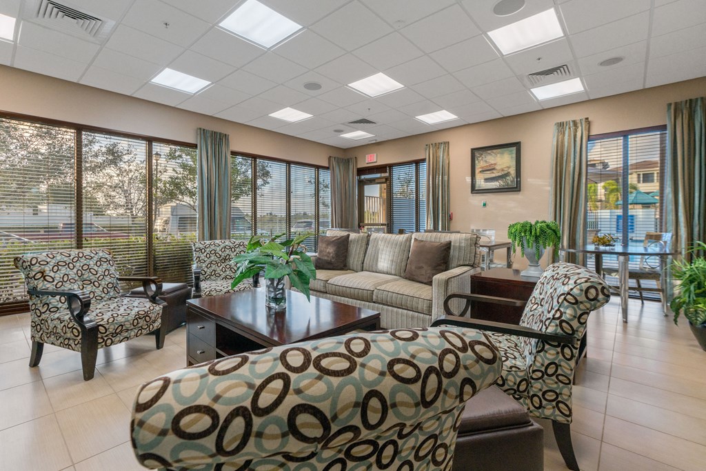 a living room with couches and chairs and a table
