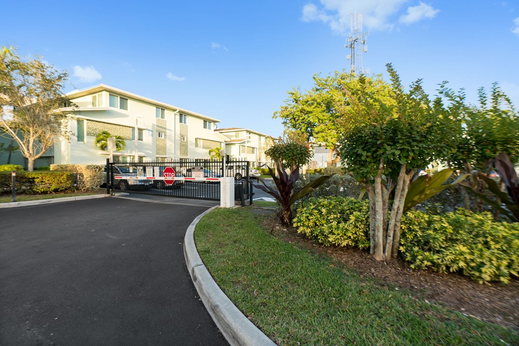 a house with a driveway and a gate in front of it