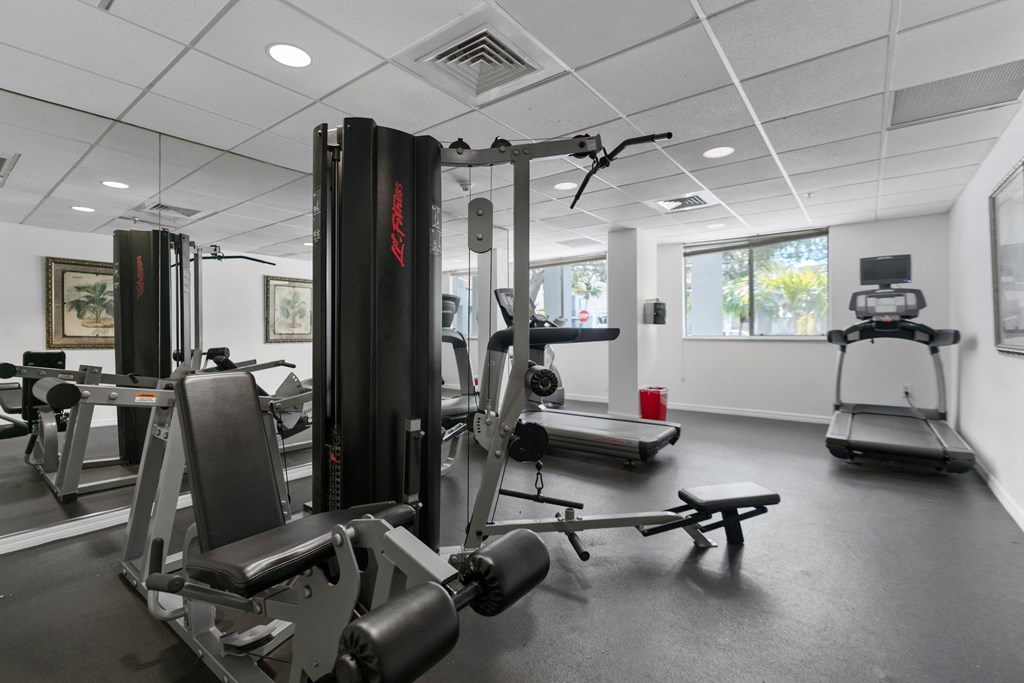 a gym with weights and other exercise equipment in a building