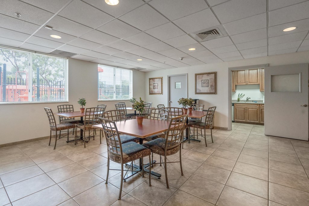 a dining room with a table and chairs in front of a window