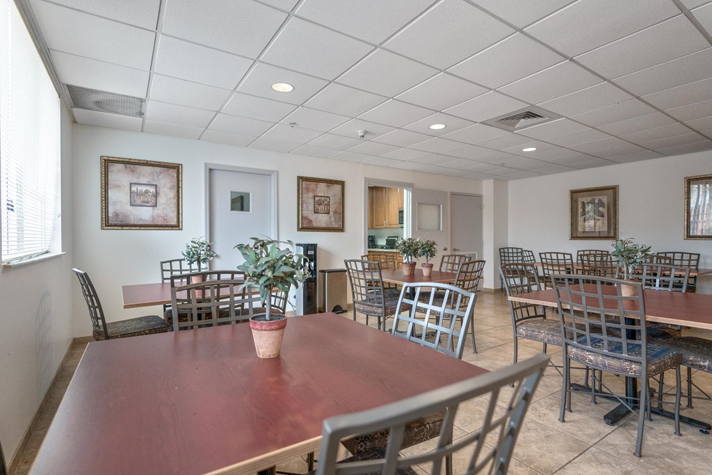 a dining room with tables and chairs and a large table