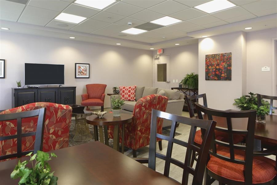 a living room with a table and chairs and a television