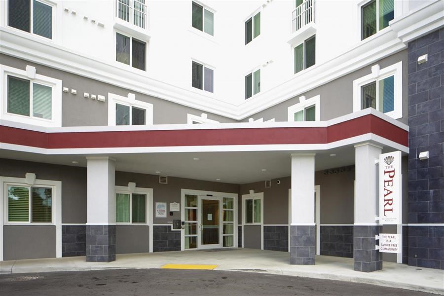 a building with a red and white facade and a door