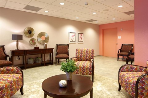 a living room with chairs and a table